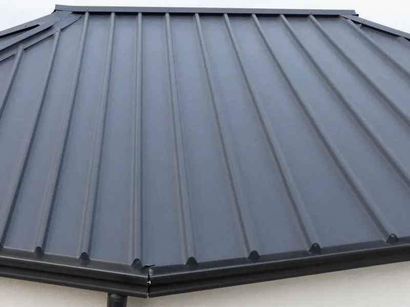 Close-up of a dark grey standing seam metal roof
